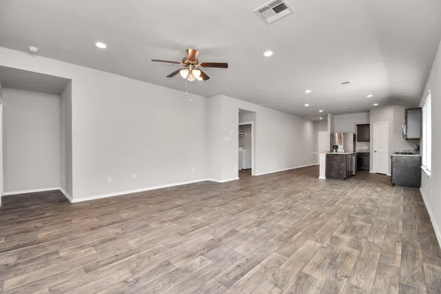 a view of a kitchen with a sink and a stove top oven