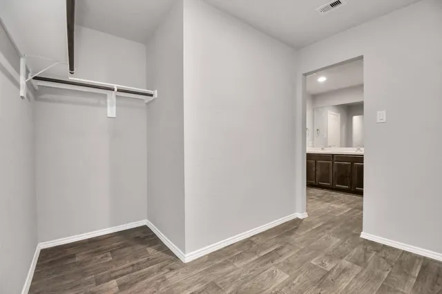 a view of a room with wooden floor