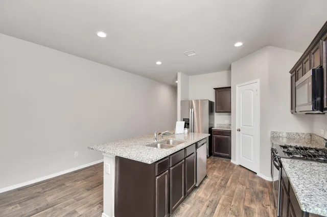 a kitchen with a sink stove and refrigerator