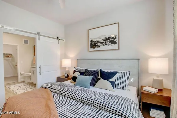 a bedroom with a bed and a couch