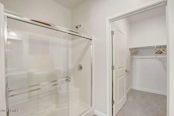 a bathroom with a shower and a glass door