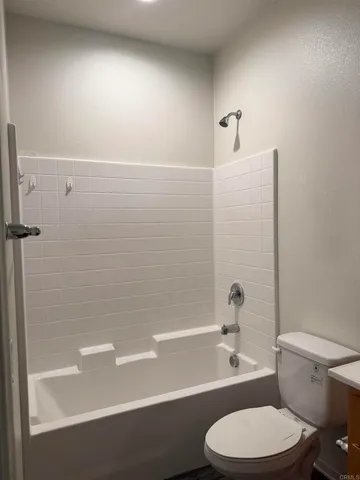 a bathroom with a toilet a sink and bathtub