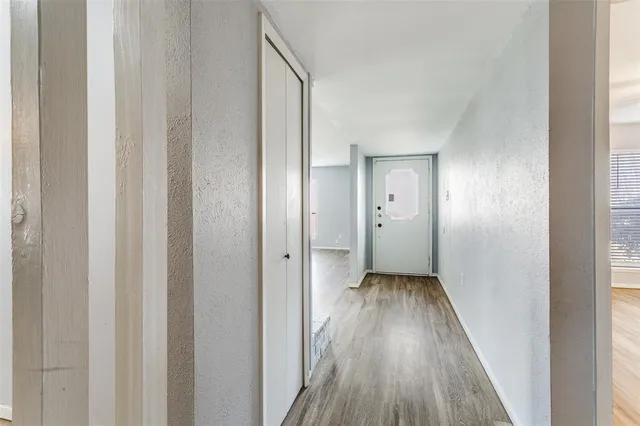 a view of a hallway with wooden floor
