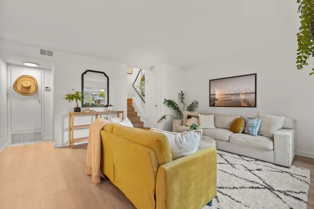 a living room with furniture and a clock