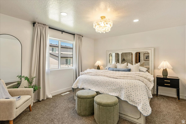 3916 South Sage Wood Avenue Mapleton, UT 84664 - Photo 15 of 33 Bright interior featuring a double window with light-filtering curtains, overhead decorative light fixture, recessed lighting, and textured carpeting