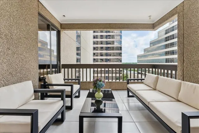 a living room with furniture and floor to ceiling window
