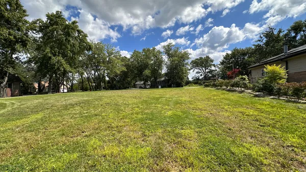 a view of outdoor space with garden and trees
