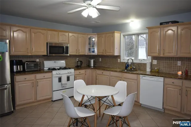 a kitchen with a sink cabinets and window