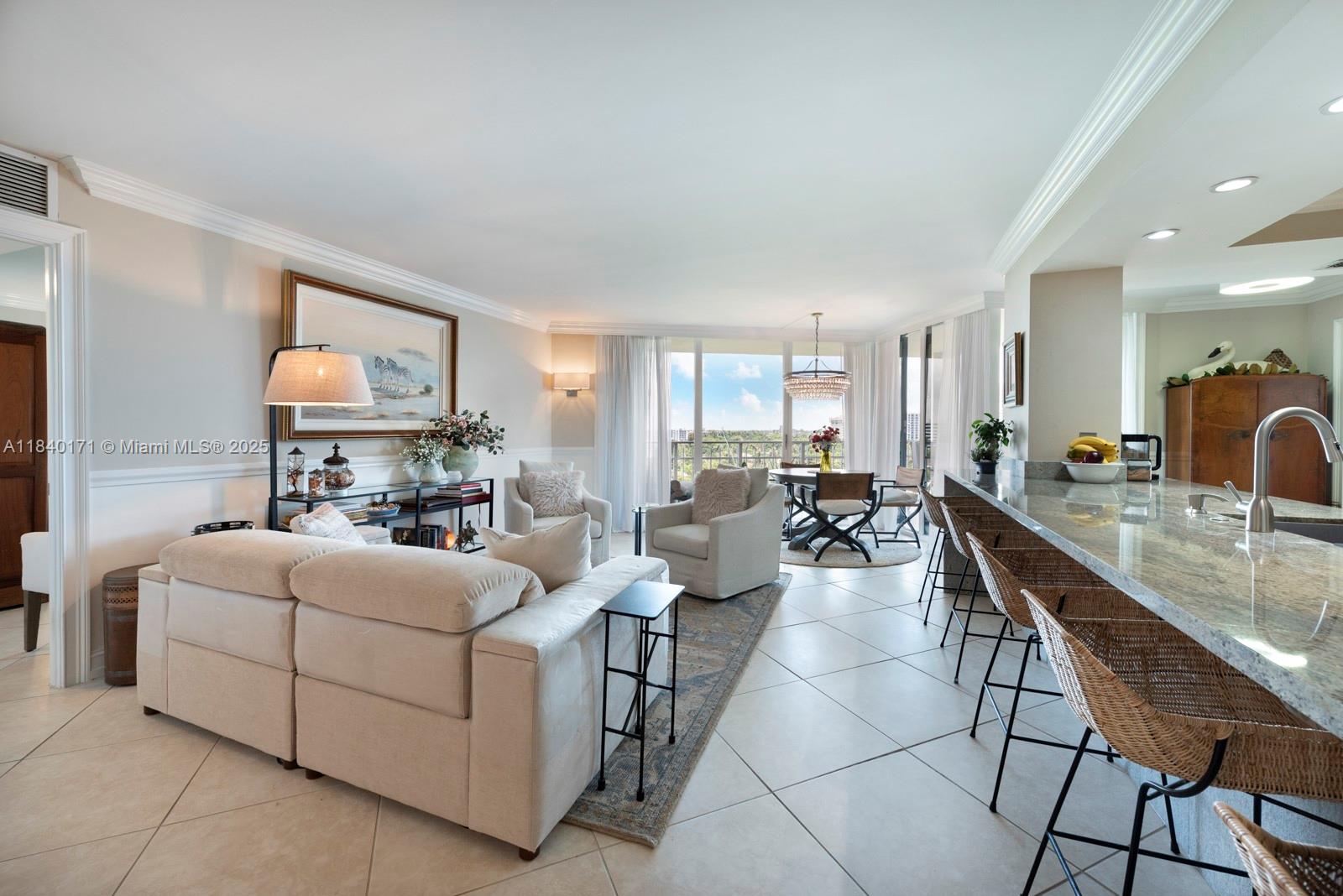 4000 Towerside Terrace, Unit 1005 Miami, FL 33138 - Photo 12 of 25 a living room with furniture a flat screen tv and a table