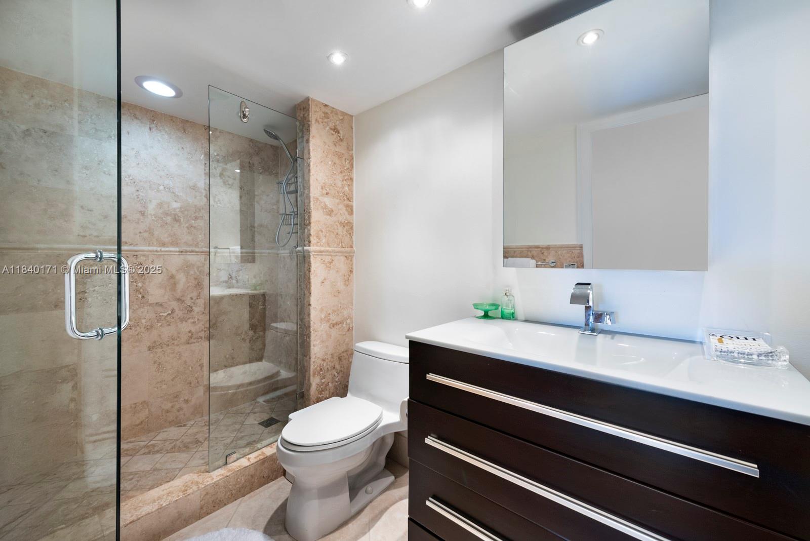 4000 Towerside Terrace, Unit 1005 Miami, FL 33138 - Photo 10 of 25 a bathroom with a sink a toilet and shower