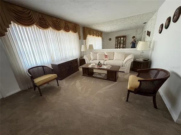 a bathroom with a sink a toilet a mirror and window