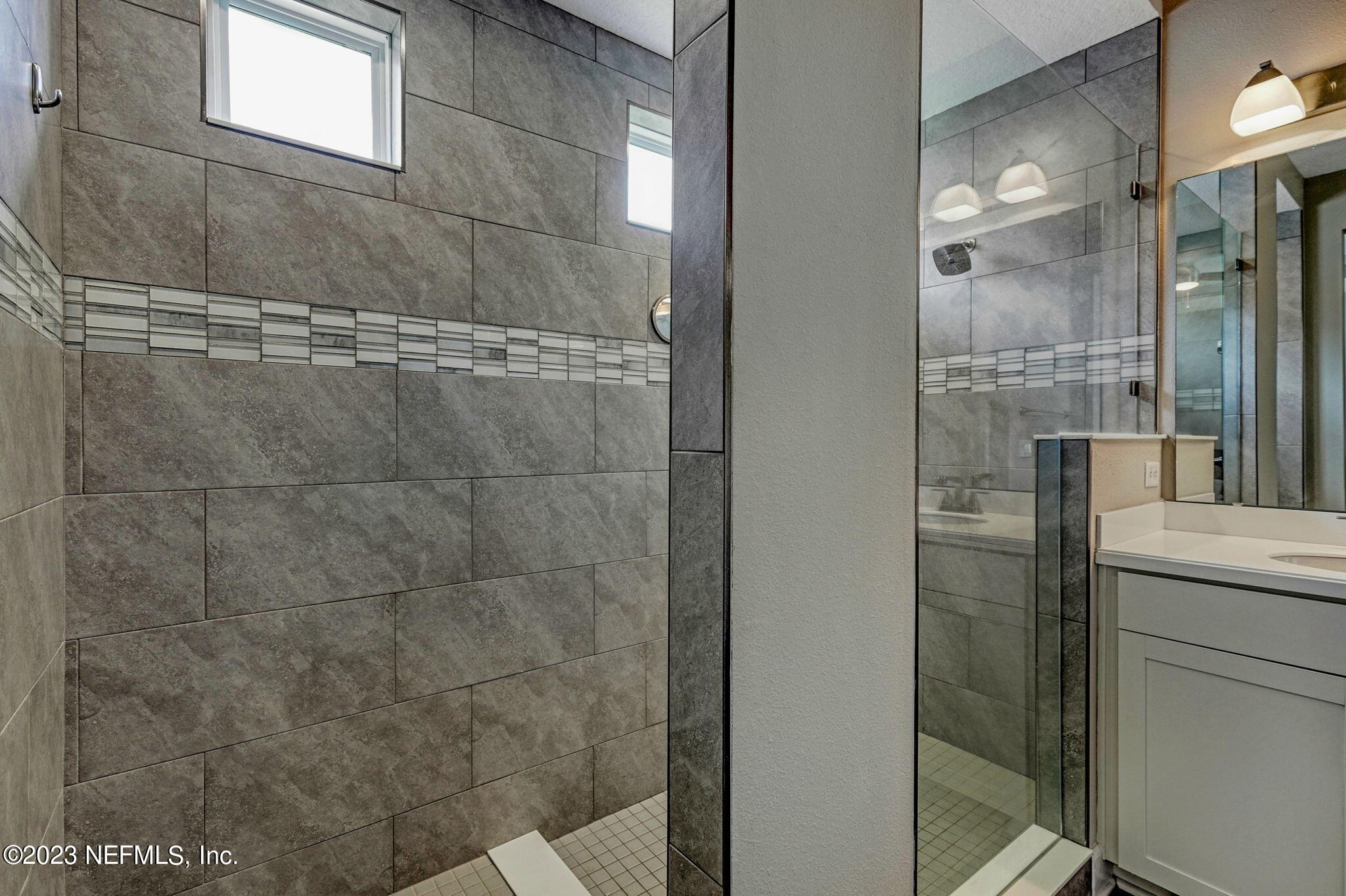 69 Willow Lake Drive St. Augustine, FL 32092 - Photo 18 of 42 a bathroom with a granite countertop shower mirror and a sink