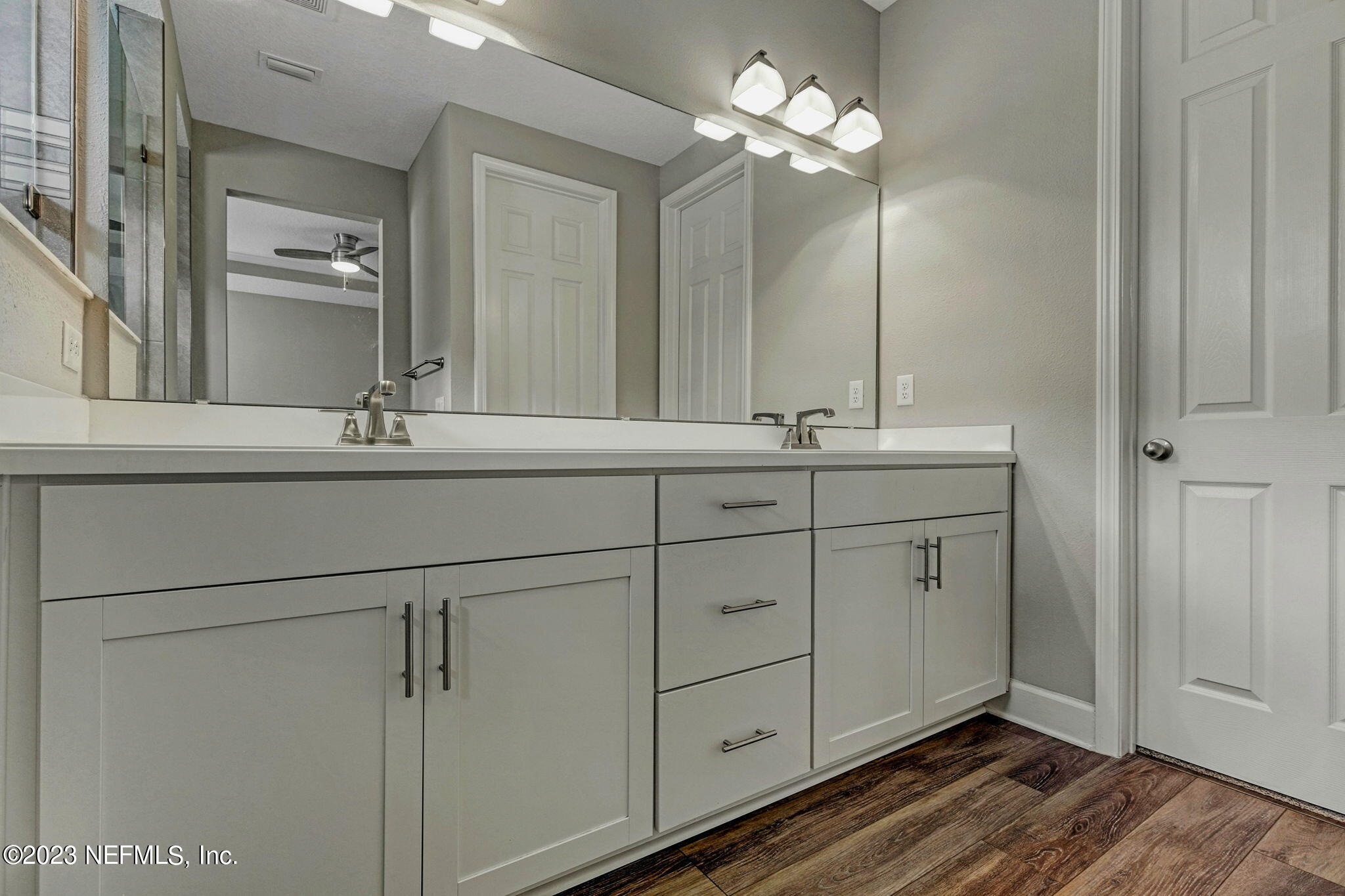 69 Willow Lake Drive St. Augustine, FL 32092 - Photo 19 of 42 a bathroom with a double vanity sink and a mirror