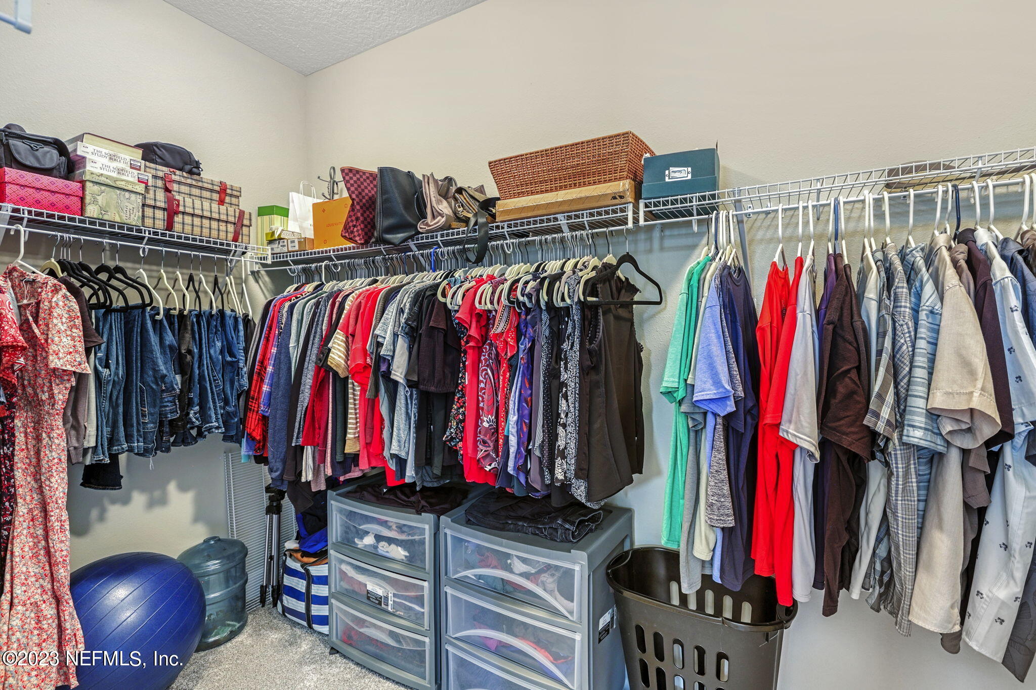 69 Willow Lake Drive St. Augustine, FL 32092 - Photo 20 of 42 a view of walk in closet with clothes and shoes