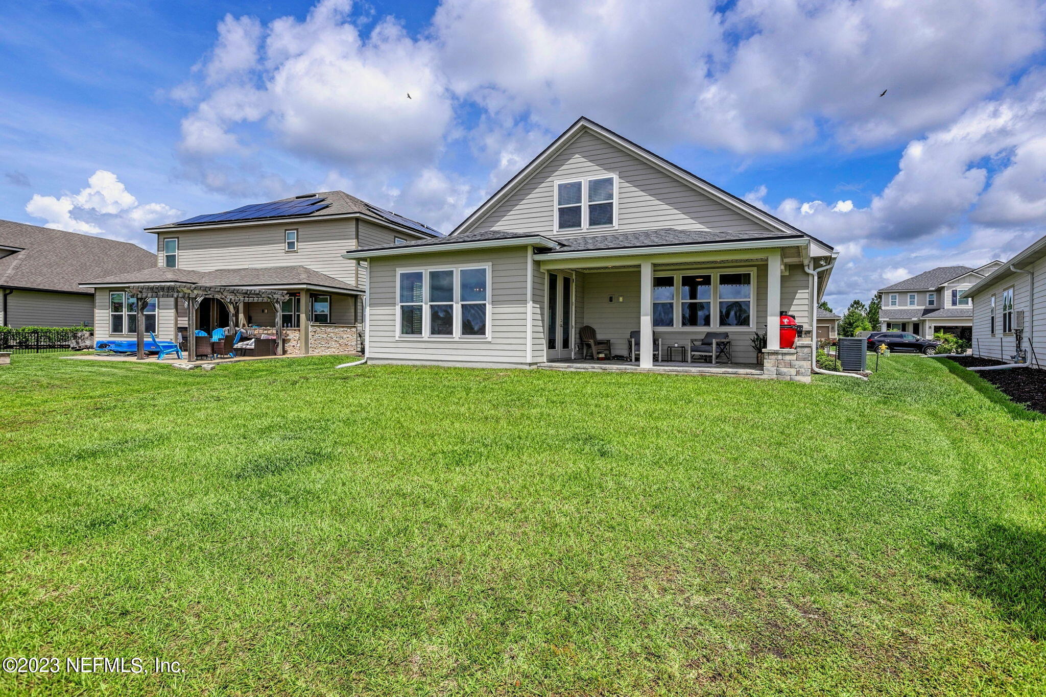 69 Willow Lake Drive St. Augustine, FL 32092 - Photo 33 of 42 a front view of a house with a big yard and potted plants