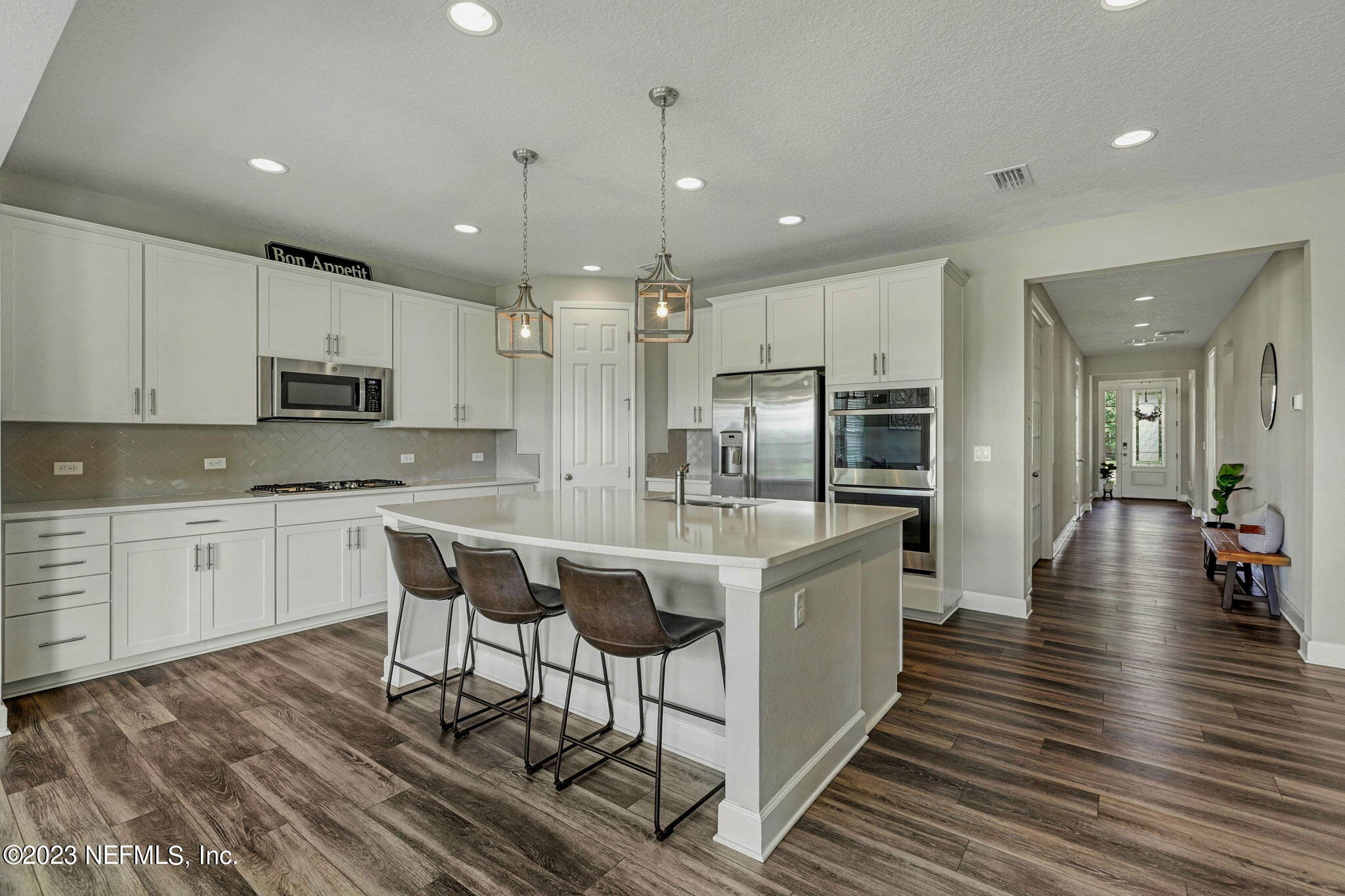 69 Willow Lake Drive St. Augustine, FL 32092 - Photo 7 of 42 a kitchen with stainless steel appliances a dining table chairs microwave and sink