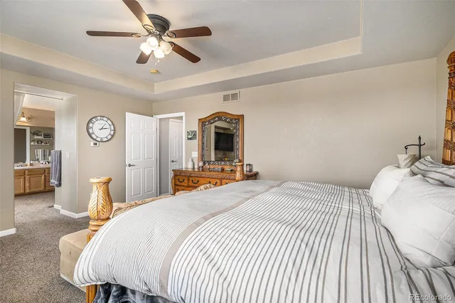 a bedroom with a bed and ceiling fan