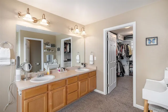 a bathroom with a double vanity sink and a mirror