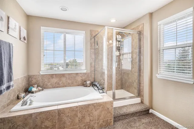 a spacious bathroom with sink shower and bathtub