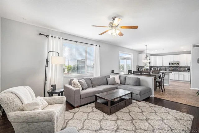 a living room with furniture and kitchen view