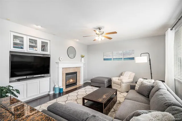 a living room with furniture a fireplace and a flat screen tv
