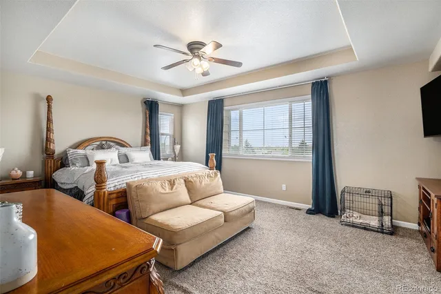 a bedroom with two beds and windows