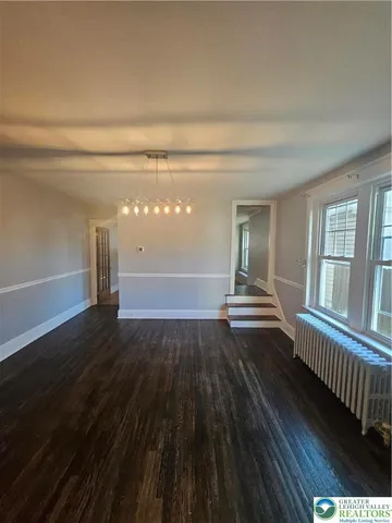 a view of wooden floor and windows in a room