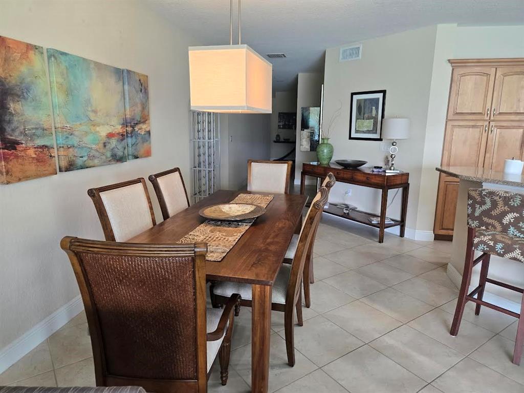 650 Golden Gate Point, Unit 301 Sarasota, FL 34236 - Photo 11 of 31 a view of a dining room with furniture and a window