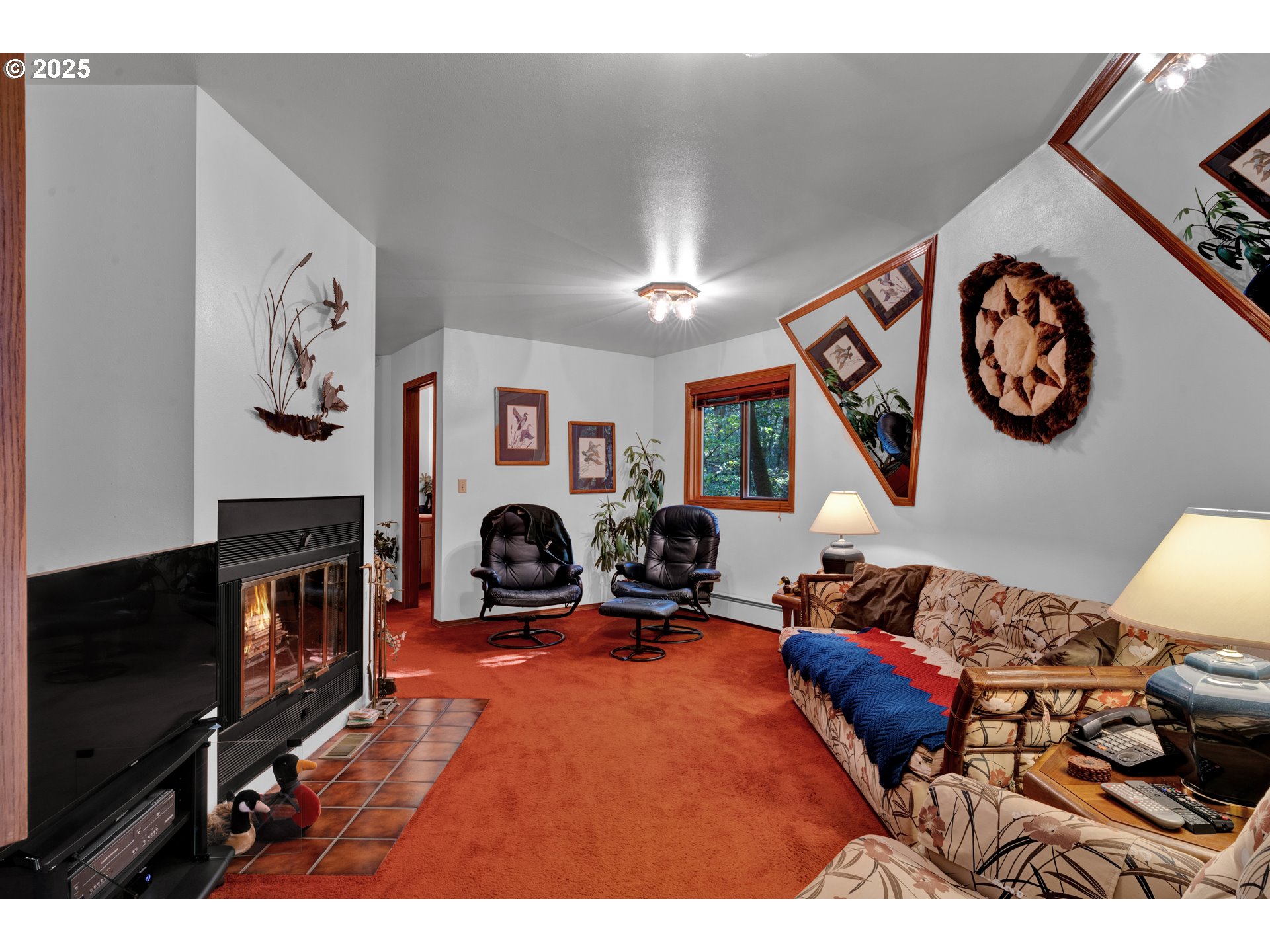 434 East 39th Avenue Eugene, OR 97405 - Photo 15 of 48 a living room with furniture a flat screen tv and a fireplace