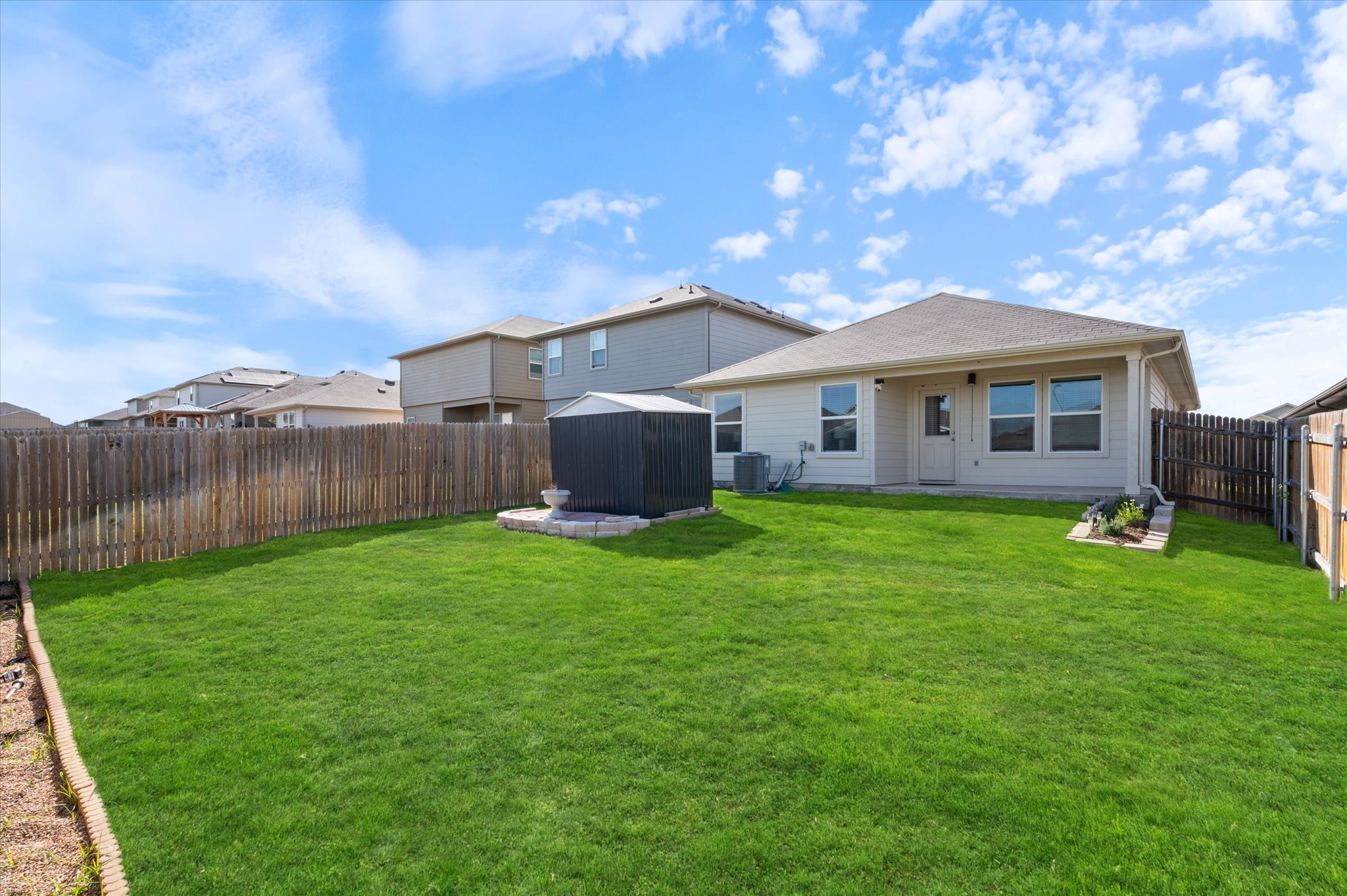 15003 Tuff Road Manor, TX 78653 - Photo 23 of 27 a view of a house with a backyard