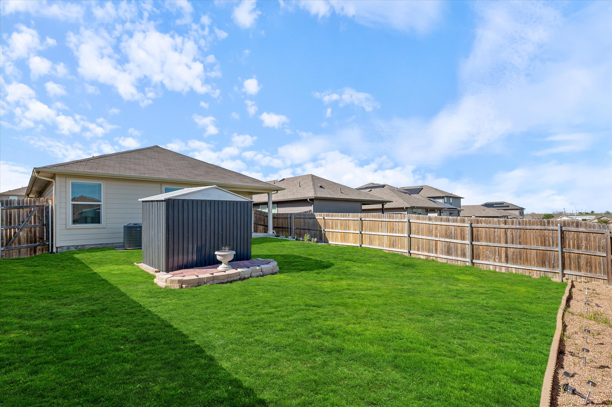 15003 Tuff Road Manor, TX 78653 - Photo 24 of 27 a backyard of a house with table and chairs