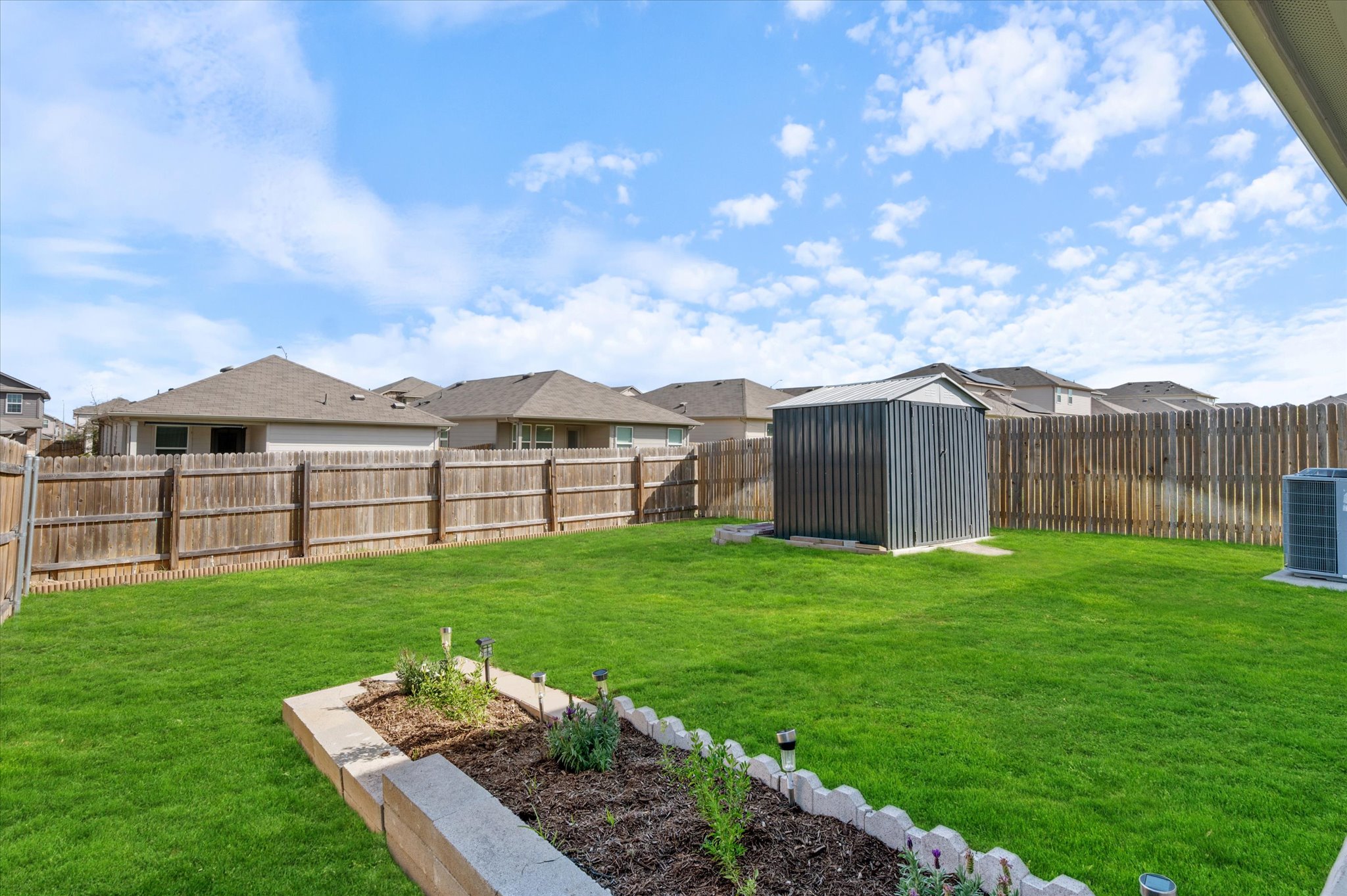 15003 Tuff Road Manor, TX 78653 - Photo 25 of 27 a view of a house with backyard and garden