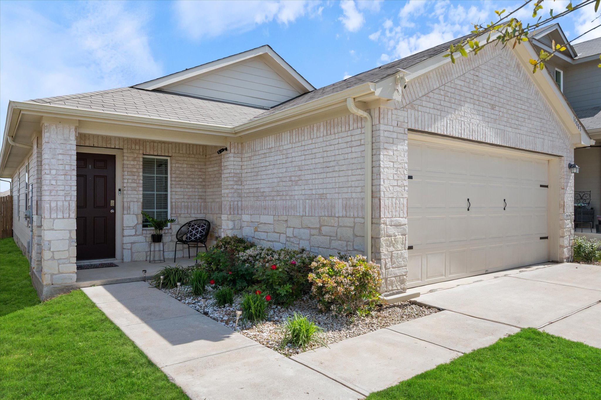 15003 Tuff Road Manor, TX 78653 - Photo 3 of 27 a front view of a house with garden