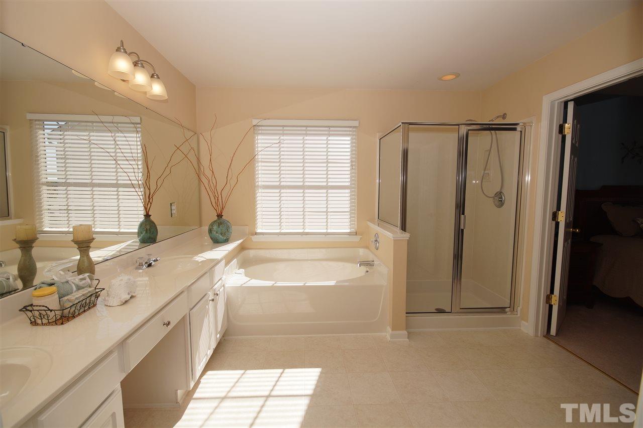 7449 Lagrange Drive Raleigh, NC 27613 - Photo 15 of 24 a spacious bathroom with a tub sink and mirror