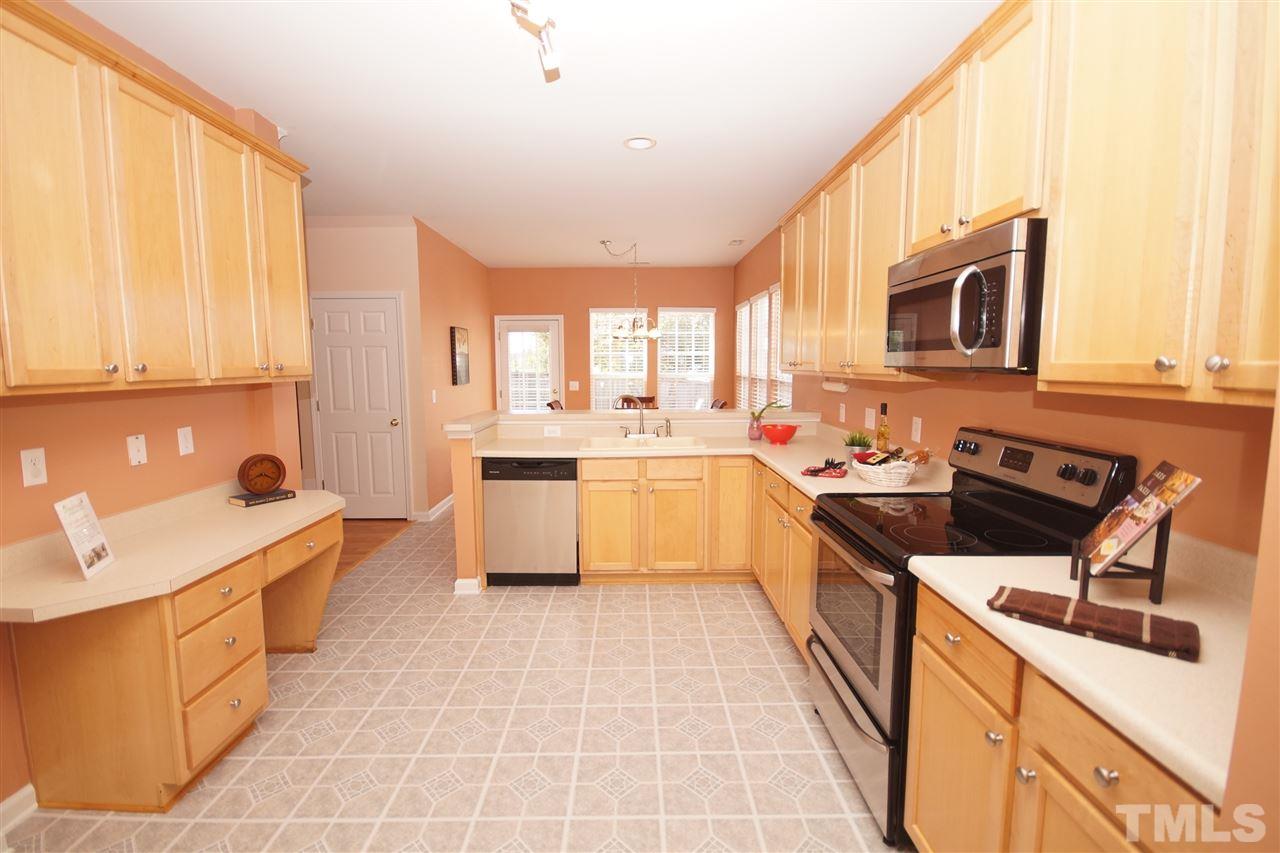 7449 Lagrange Drive Raleigh, NC 27613 - Photo 5 of 24 a kitchen with stainless steel appliances a stove sink and cabinets