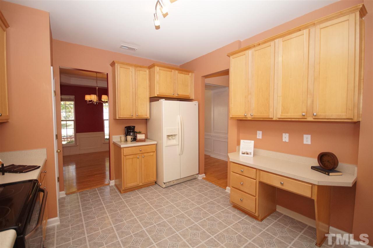 7449 Lagrange Drive Raleigh, NC 27613 - Photo 6 of 24 a kitchen with a refrigerator and a stove