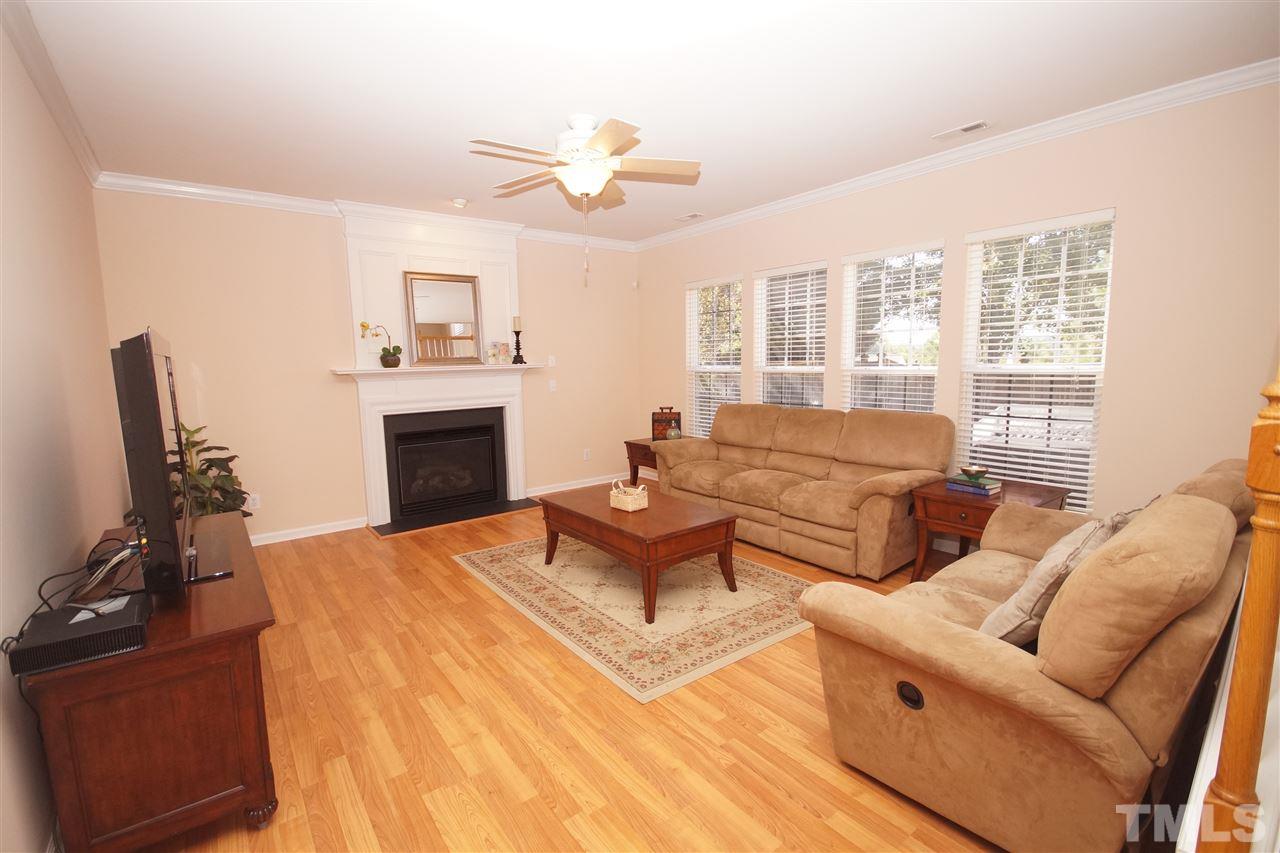 7449 Lagrange Drive Raleigh, NC 27613 - Photo 9 of 24 a living room with furniture fireplace and a flat screen tv