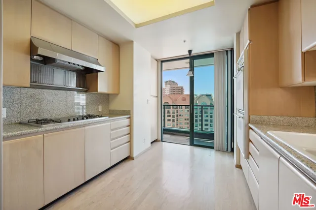 a kitchen with stainless steel appliances granite countertop a stove and a refrigerator