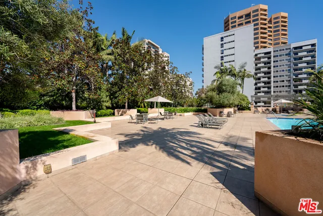 a view of a patio with swimming pool table and chairs