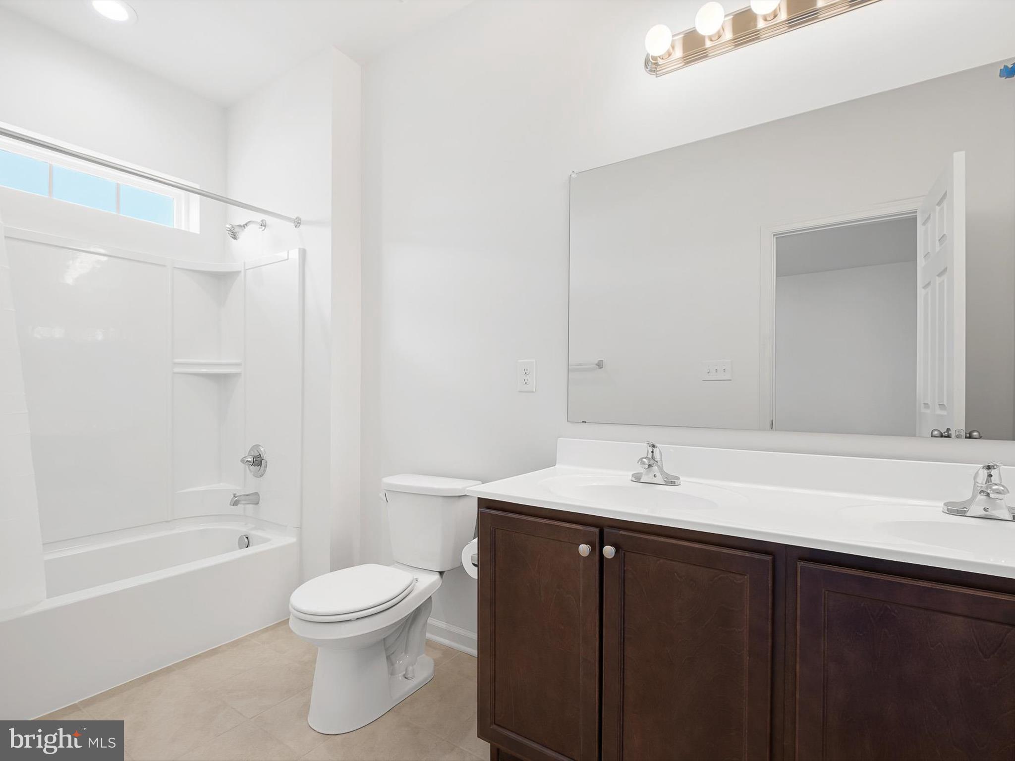 415 Lenape Way Claymont, DE 19703 - Photo 19 of 26 a bathroom with a sink a toilet and a bathtub