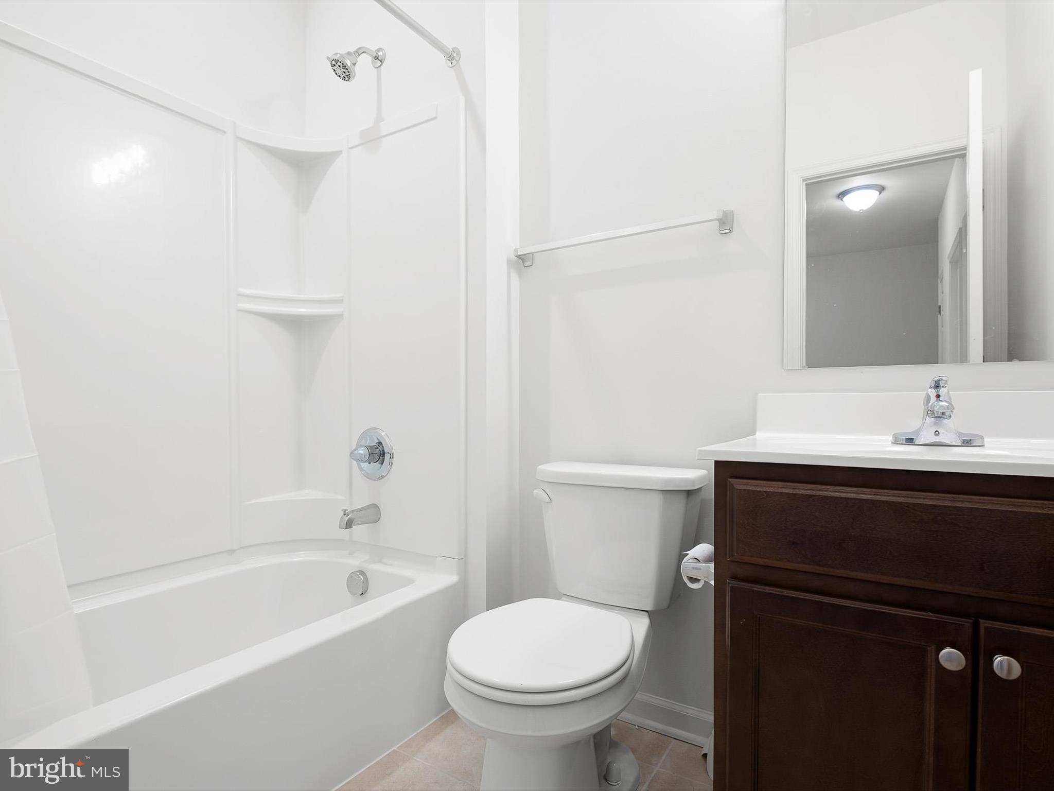 415 Lenape Way Claymont, DE 19703 - Photo 23 of 26 a bathroom with a sink a toilet and shower