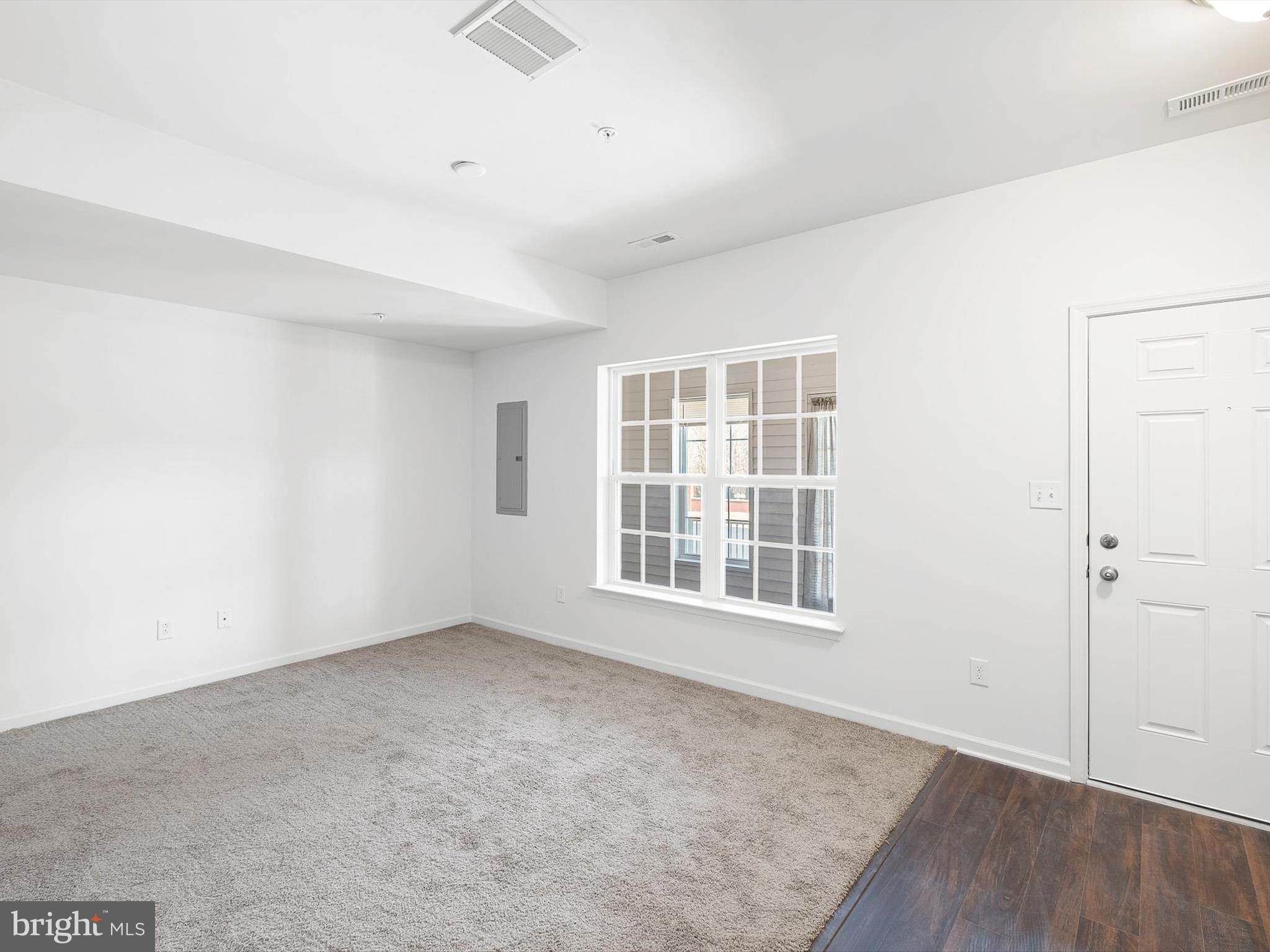 415 Lenape Way Claymont, DE 19703 - Photo 3 of 26 an empty room with wooden floor and windows