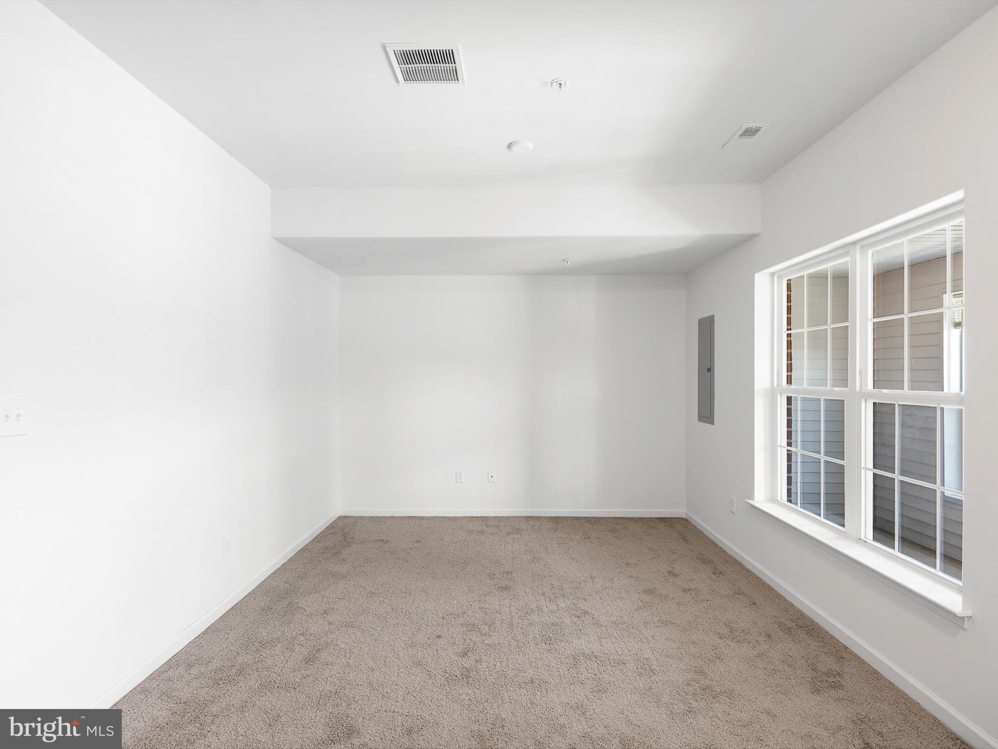 415 Lenape Way Claymont, DE 19703 - Photo 4 of 26 a view of an empty room with a window