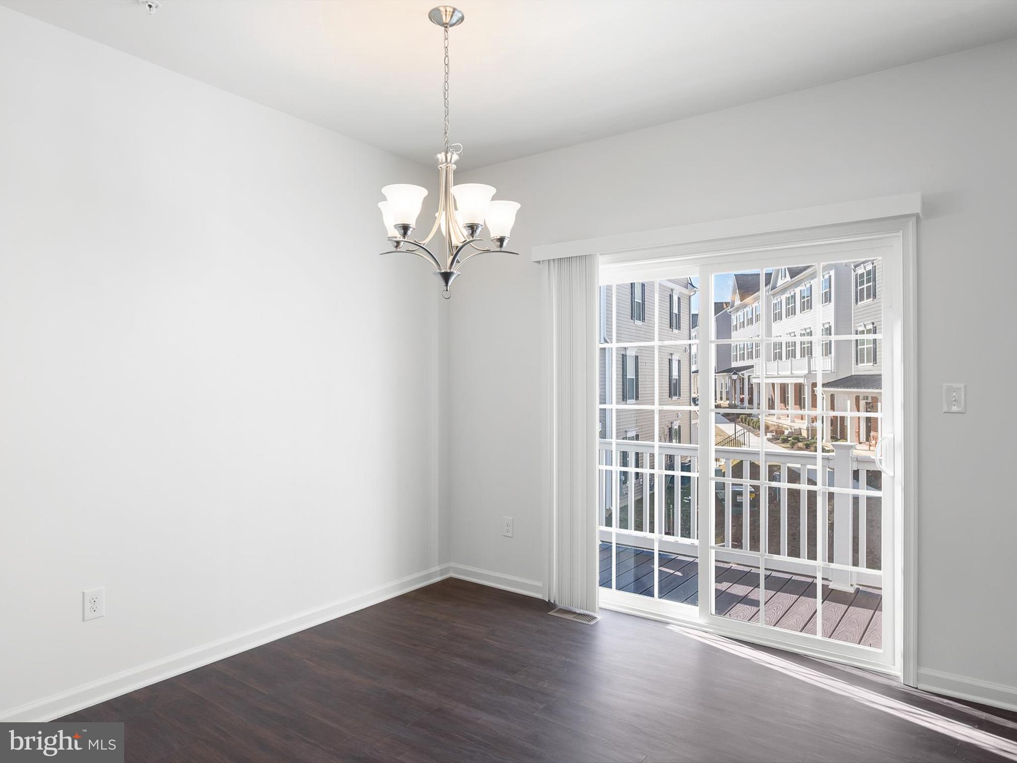 415 Lenape Way Claymont, DE 19703 - Photo 8 of 26 a view of an empty room with wooden floor and a window