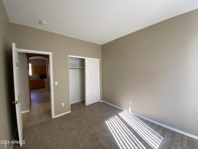 an empty room with closet area