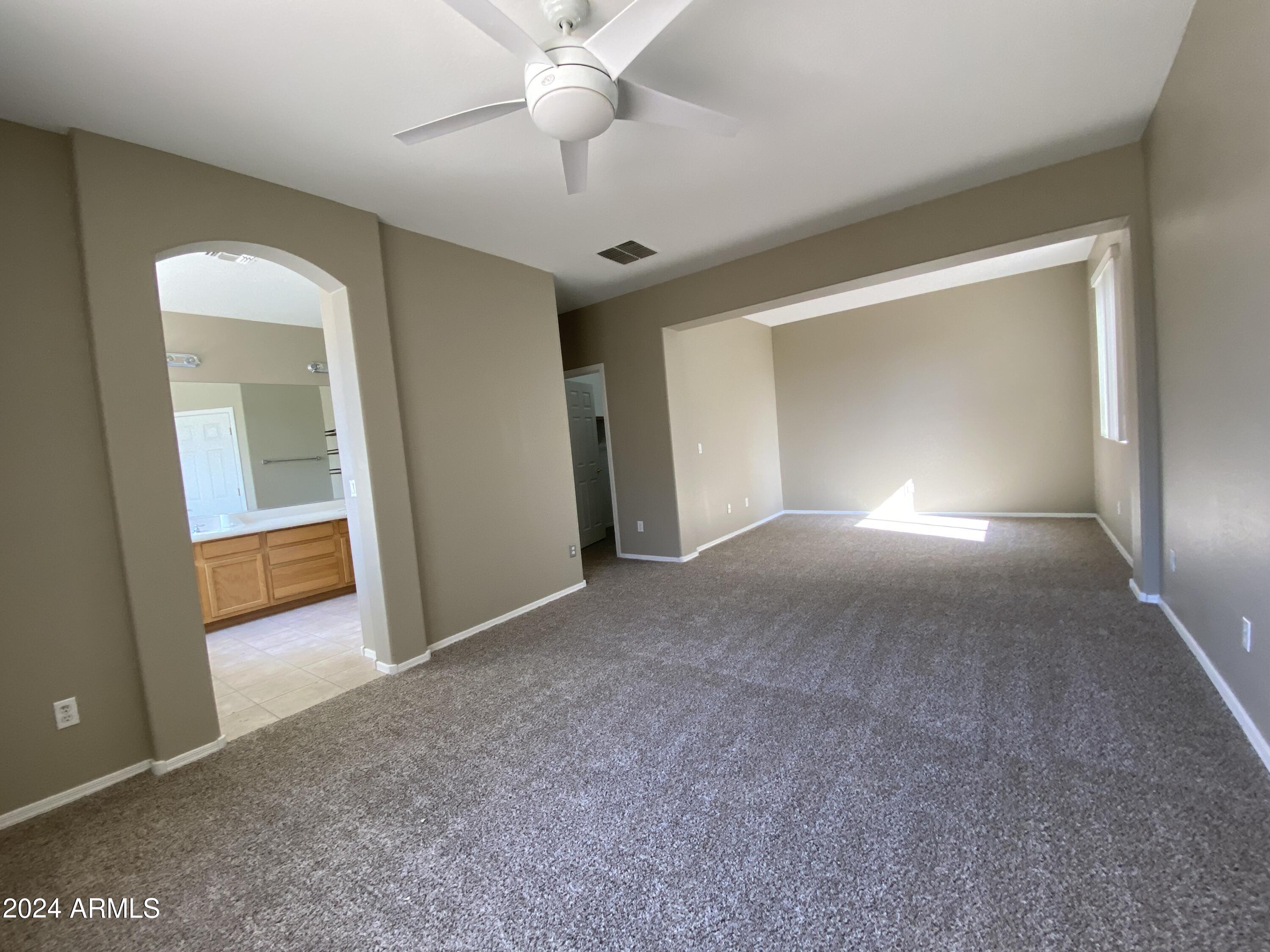 7217 West Kings Avenue Peoria, AZ 85382 - Photo 10 of 19 a view of a big room with closet and a ceiling fan