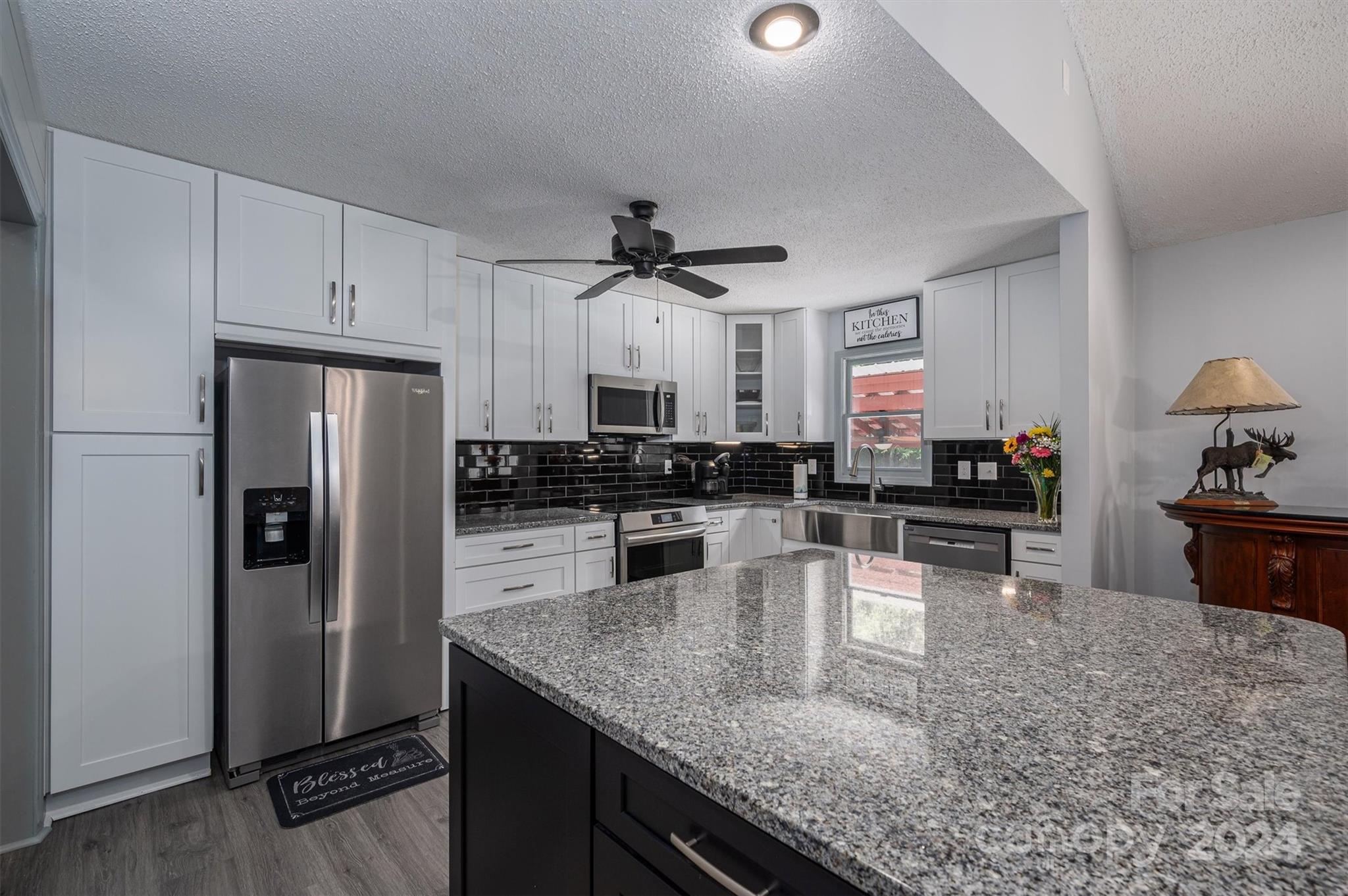 459 Patrick Road Gastonia, NC 28056 - Photo 12 of 39 a kitchen with granite countertop a refrigerator a stove a sink a counter space and cabinets