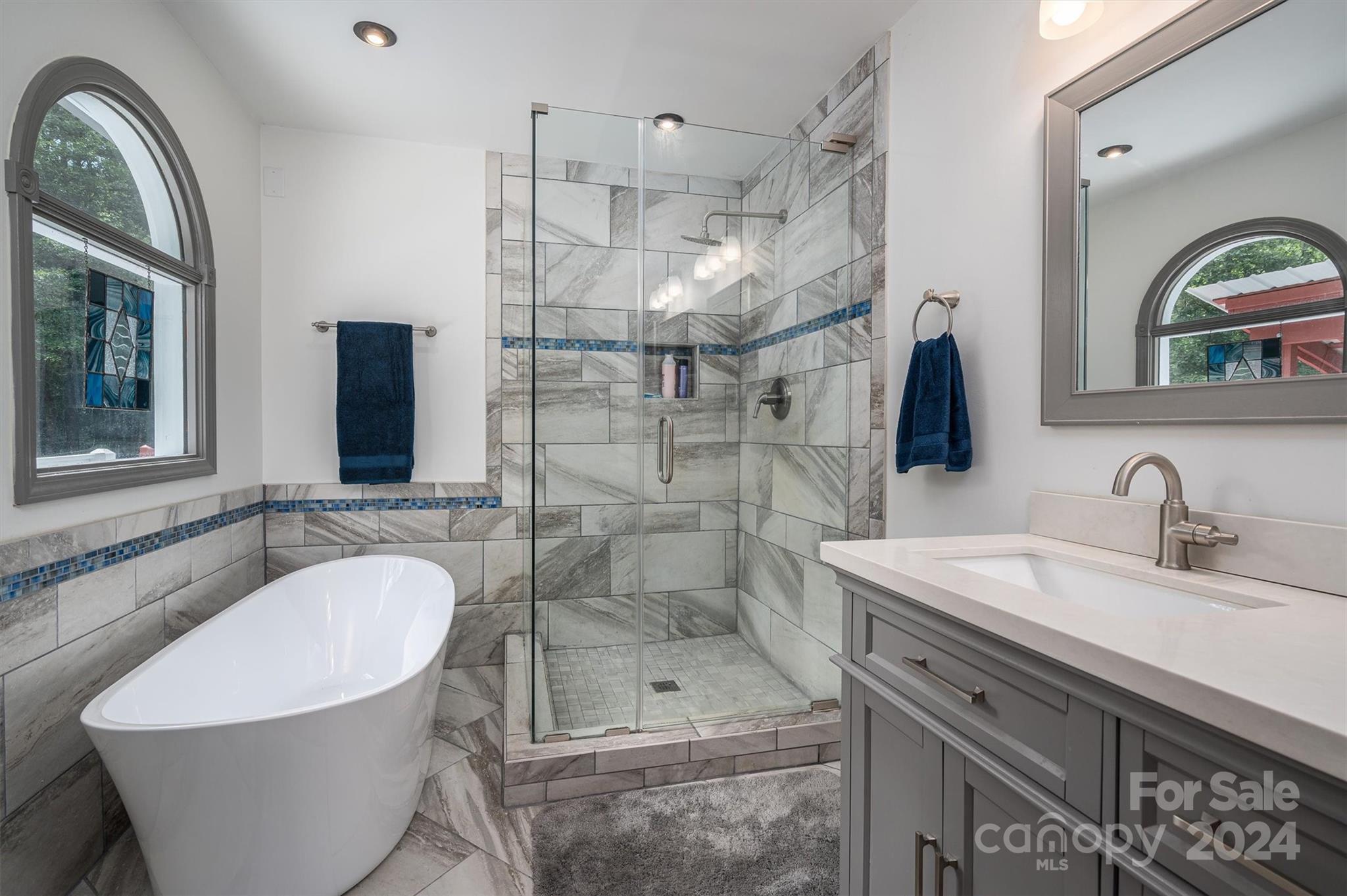 459 Patrick Road Gastonia, NC 28056 - Photo 21 of 39 a bathroom with a sink a mirror a bathtub and shower