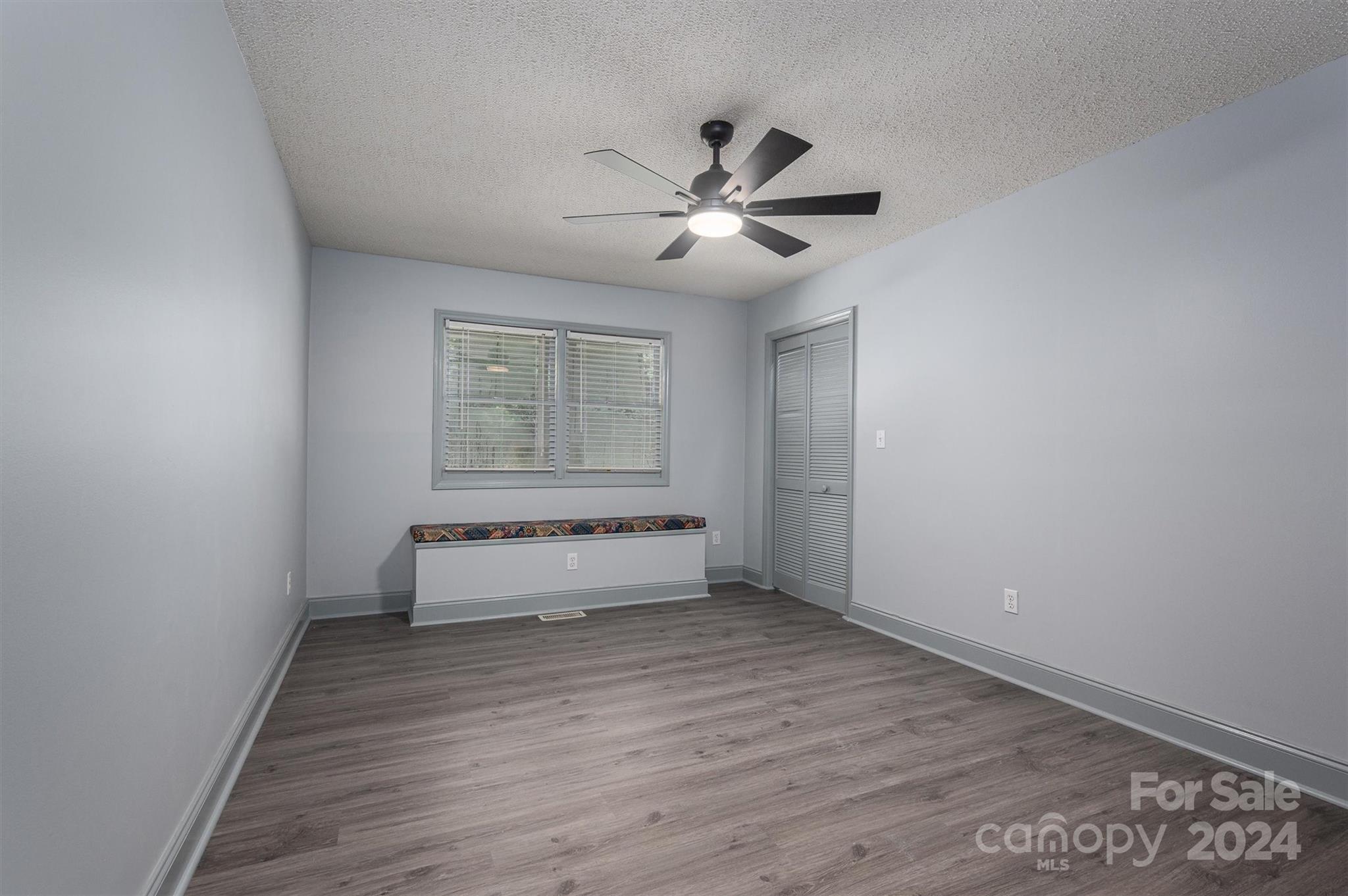 459 Patrick Road Gastonia, NC 28056 - Photo 25 of 39 a view of empty room with wooden floor and fan
