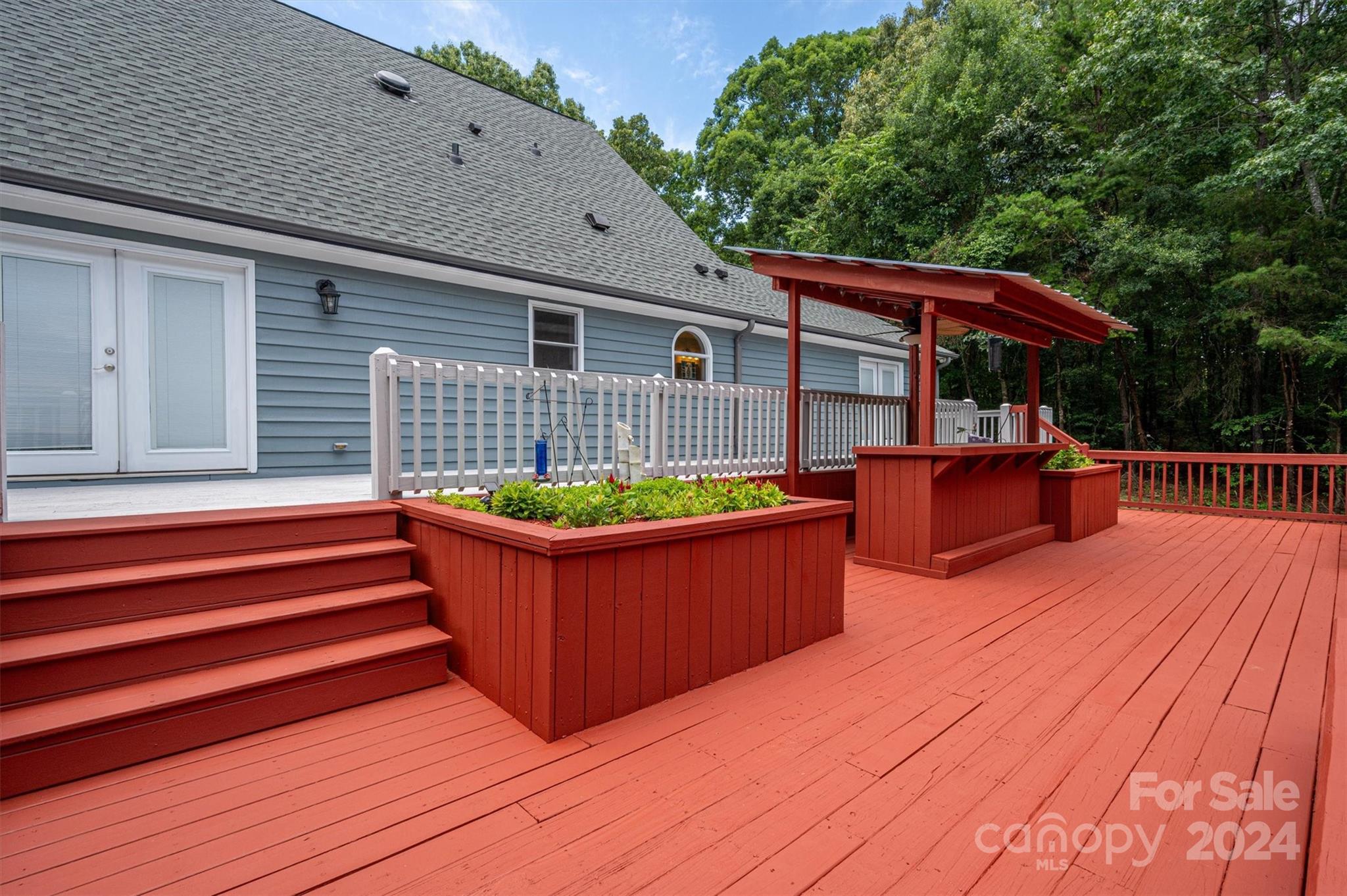 459 Patrick Road Gastonia, NC 28056 - Photo 34 of 39 a view of a house with wooden deck and outdoor seating